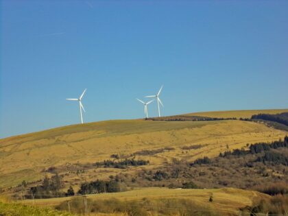 Windmills on a hill in the distance